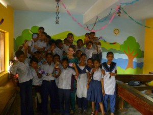 Lauren in newly painted classrooms with students