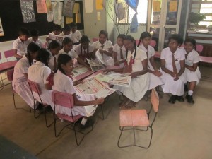 Students reading English newspaper, First News, at Bob's project