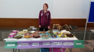 Sam holding her cake sale that raised £50.